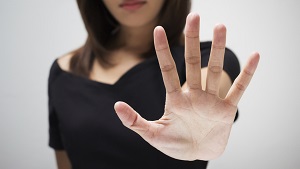 Young woman showing her denial with NO on her hand
